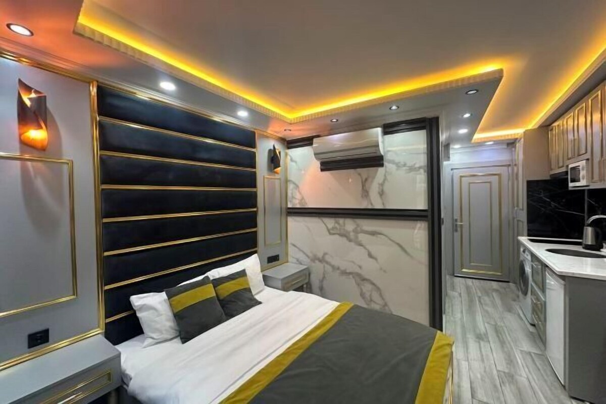 A modern bedroom with a large bed, bedside tables, and a built-in wardrobe.