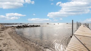 A wooden pier extending into calm waters with boats anchored nearby. - 3 bedroom stunning home in Hejls (Hejls)