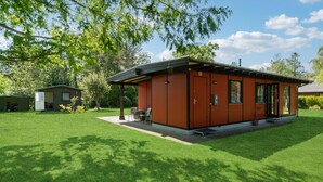 A single-story house with a covered patio area, a small attached garage, and a well-maintained lawn. - Gorgeous home in Gørlev with WiFi (Gørlev)