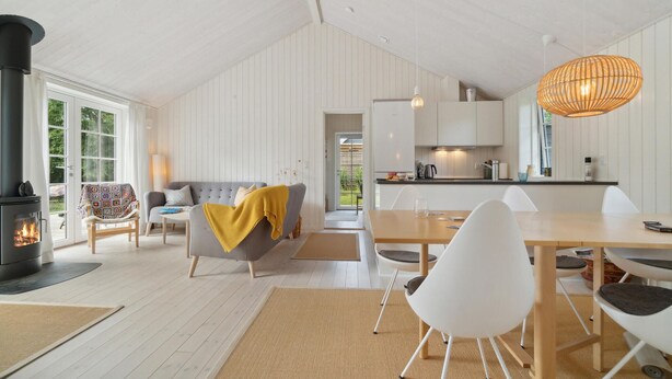 A modern interior with a fireplace, a dining area, and a kitchen. - Amazing home in Gilleleje with WiFi (Gilleleje)