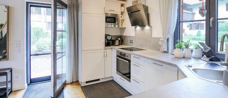 Fridge, stovetop, dishwasher, coffee/tea maker