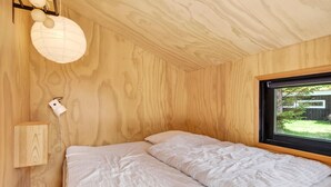 A bedroom with a wooden ceiling, a window, and a bed with a striped pillow. - Awesome home in Saltum with WiFi (Saltum)