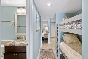 Cozy bedroom with a bunk bed, bedside table, and wardrobe, perfect for a comfortable stay.
