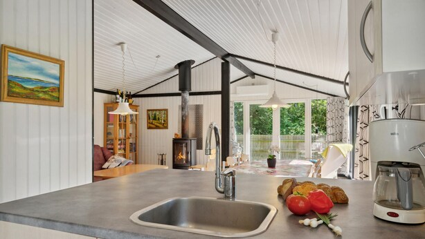 A modern kitchen with a large island, stainless steel appliances, and a view of the outdoors. - Nice home in Højslev with kitchen (Højslev)