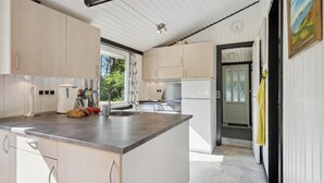 A modern kitchen with light wood cabinets, a stainless steel countertop, and a built-in oven. - Nice home in Højslev with kitchen (Højslev)