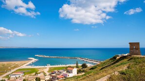 A coastal town with a prominent tower, a marina, and a clear blue sky. - Stunning home in Menfi (Menfi)
