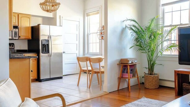 A modern living space with a kitchen, dining area, and seating area. - Cozy 2BR/2BA Apt on Broadway (Newport)