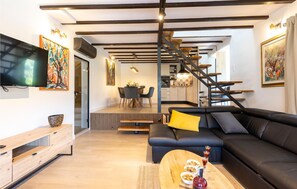 Relax in this stylish living space with a comfortable sofa, coffee table, and flat-screen TV.