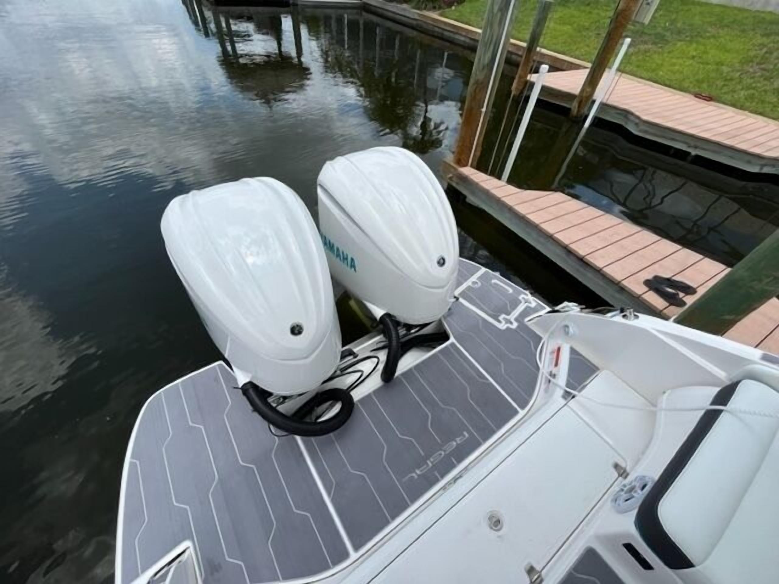 A boat with two Yamaha outboard motors and a grey patterned deck.