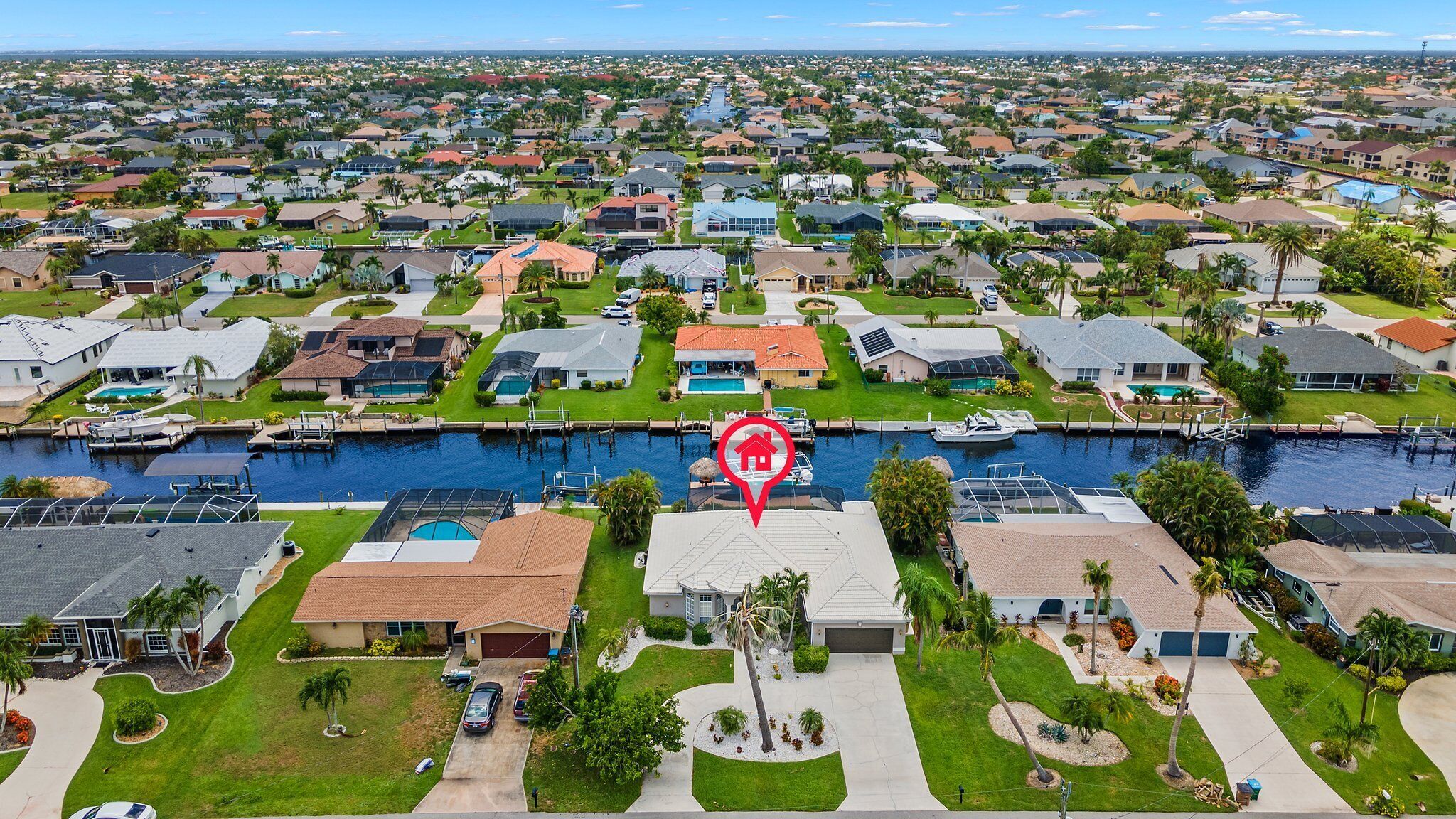 A residential area with houses, a canal, and a boat dock.