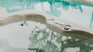 A swimming pool with a hot tub, surrounded by a wooden fence, and two light blue chairs in the background. - Pool, Hot Tub, Enclosed Patio, Close to Everything-A Million Memories (St. Augustine)