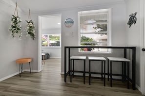 Enter a serene space with a bench and stool, surrounded by natural light and a decorative touch.