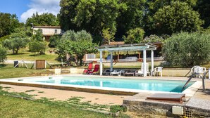 A swimming pool with a covered seating area and lounge chairs. - Beautiful home in Monteverdi M.mo PI (Monteverdi M.mo PI)