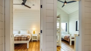 A bedroom with a bed, bedside table, lamp, and a ceiling fan. - Saddleback - Parmachenee A-Frame #1 - SkiFrame (Sandy River Plantation)