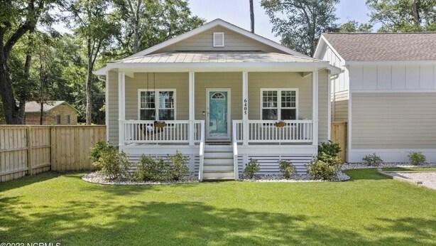 A single-story house with a front porch, a front door, and a mailbox. - Only TWO MILES to the beach! Custom bungalow. Fenced-in yard! (Ocean Isle Beach)