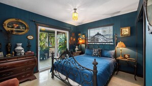 A bedroom with a bed, dresser, nightstand, and a window with a view of greenery. - BOHO Paradise, KING Bed, POOL, 1 month+LONG Term Stays,PET FRIENDLY (Pompano Beach)
