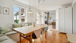 A modern kitchen with wooden flooring, a central island, and pendant lighting. - 2 bedroom awesome home in Haarby (Haarby)