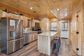 Enjoy cooking in this well-equipped kitchen with a central island and stainless steel appliances.