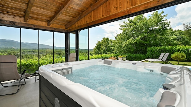 A hot tub with a view of a lush landscape and mountains. - Nice home in Stubicke Toplice with sauna (Stubicke Toplice)