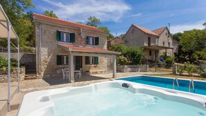 A stone house with a swimming pool and outdoor seating. - Gorgeous home in Bajagic (Bajagic)