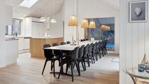 A modern kitchen with white cabinets, a wooden island, and pendant lights. - Nice home in Krakow am See with sauna (Krakow am See)