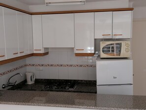 Fridge, microwave, coffee/tea maker, cookware/dishes/utensils