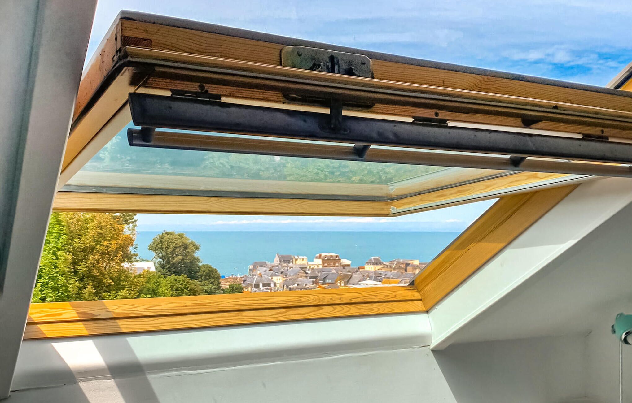A skylight with a view of a coastal town.