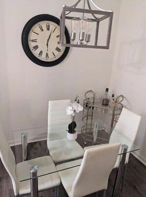 Enjoy meals in this stylish dining area with a glass-top table and comfortable seating.