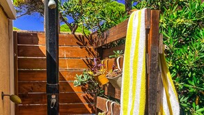 A wooden deck with a black outdoor light fixture, a wooden gate, and a yellow and white striped towel hanging on a wooden post. - 10 pax, Family friendly, 2 mins walk to the beach, sea view. (Hyères)