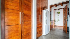 A kitchen with wooden cabinets and a white refrigerator.