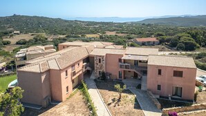 A residential building with multiple units, a courtyard, and a view of the surrounding landscape.