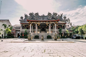 Traditional Chinese architecture with ornate columns and a decorative roof.