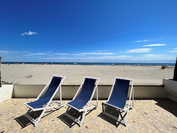 Rannalla, aurinkotuoleja