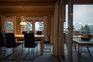 Enjoy meals in a warm and inviting dining area with a view of the surrounding landscape.