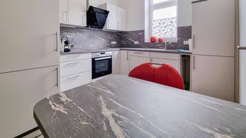 Fridge, stovetop, dishwasher, coffee/tea maker