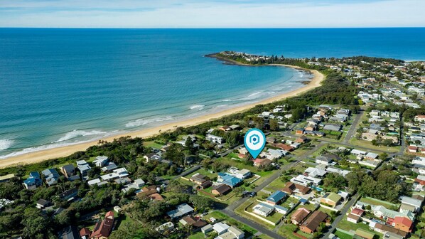 Overlooking the serene beach with gentle waves and sandy shore.