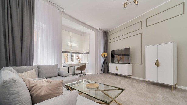 A modern living room with a sofa, a glass coffee table, a TV, and a cabinet. - Elegant Apartment in Tenement House | Center, 2 Desks for Work (Poznan)