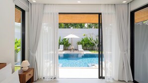 A modern bedroom with a view of a swimming pool, white curtains, and a wooden ceiling. -  Anchan Villas Phuket - Private 4 Bedroom Signature Pool Villa by Escape Villas (Choeng Thale)
