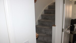 A staircase with carpeted steps leading to a landing. - Family Home 5-bed House in Birmingham City Centre (Birmingham)