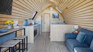 A compact, wooden interior with a kitchenette, a dining area, and a seating space. - The West Front, Cathedral View - Hot Tub - Pets - Free Parking & WiFi (Wells)