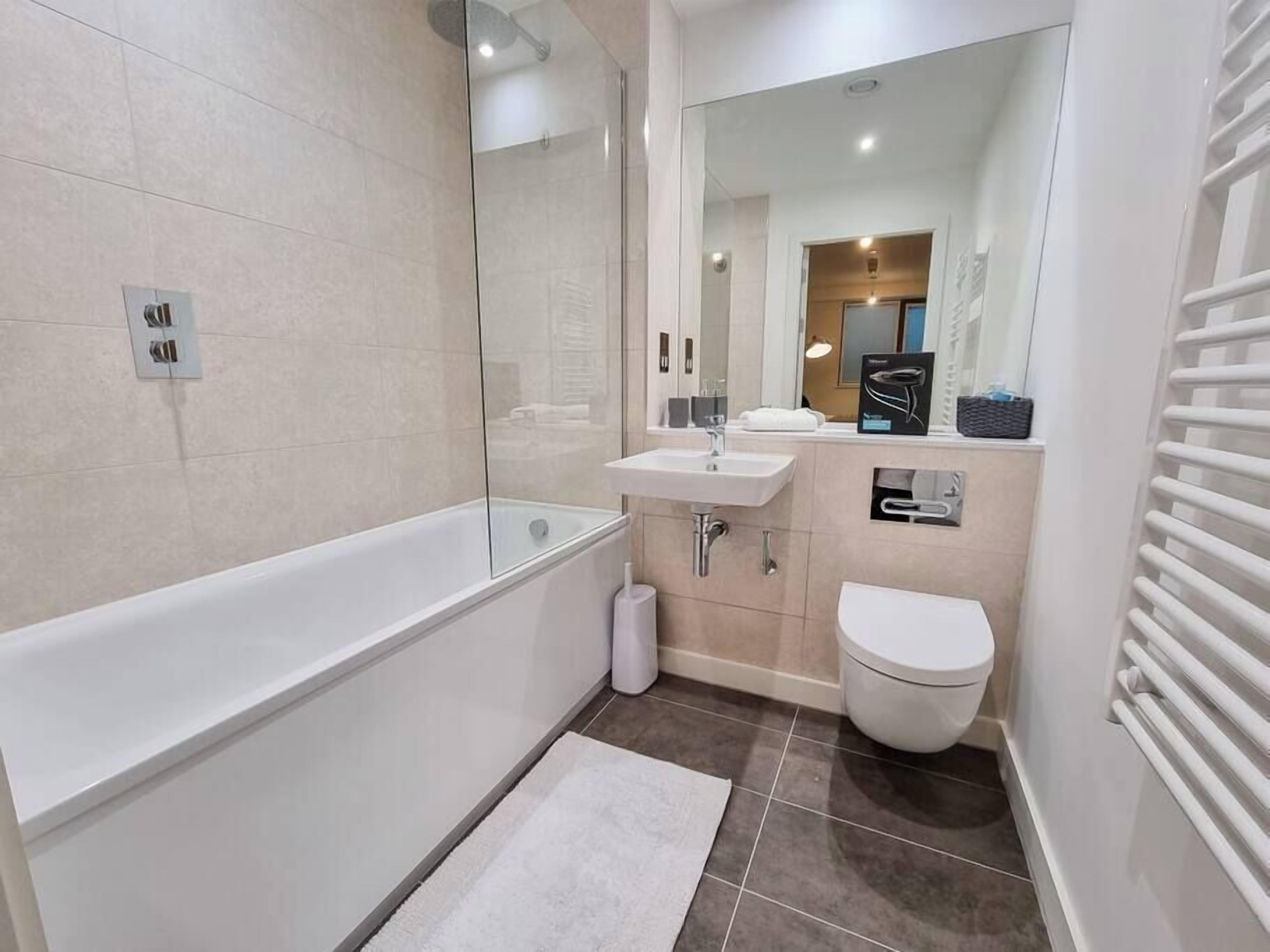 Bathtub, hair dryer, towels, soap