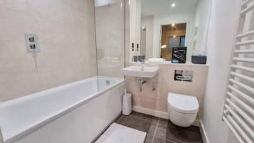 Bathtub, hair dryer, towels, soap