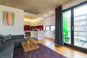 A modern apartment with a living room, kitchen, and balcony. - 1 Bed Ancoats Canalside Flat | City Centre (Manchester)