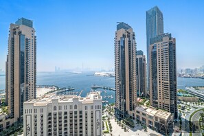 A high-rise building with a marina and water views. - WelHome - Incredible Creek Views From Th (Dubai)