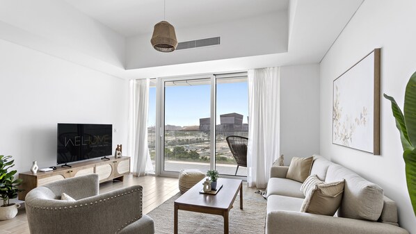 Deluxe Apartment | Living area | 50-inch Smart TV with cable channels, Netflix, streaming services - WelHome - Urban Tranquil Retreat In The Heart of Yas Island (Abu Dhabi)