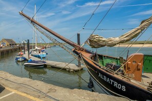 Boats dock at the pier, offering access to the calm waters.