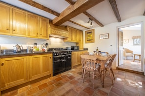 Enjoy cooking in this fully equipped kitchen with a black stove, microwave, and ample countertop space.