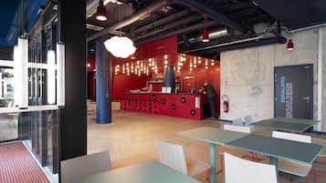 A modern interior with a bar area, seating, and a visible exit door.