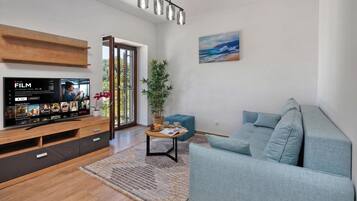 Family Apartment, Multiple Bedrooms, Sea Facing (Seafront Apartment Nana 1) | Living area | 21-inch Smart TV with cable channels