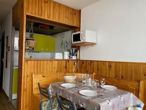 A compact kitchen with a microwave, a toaster, and a sink.